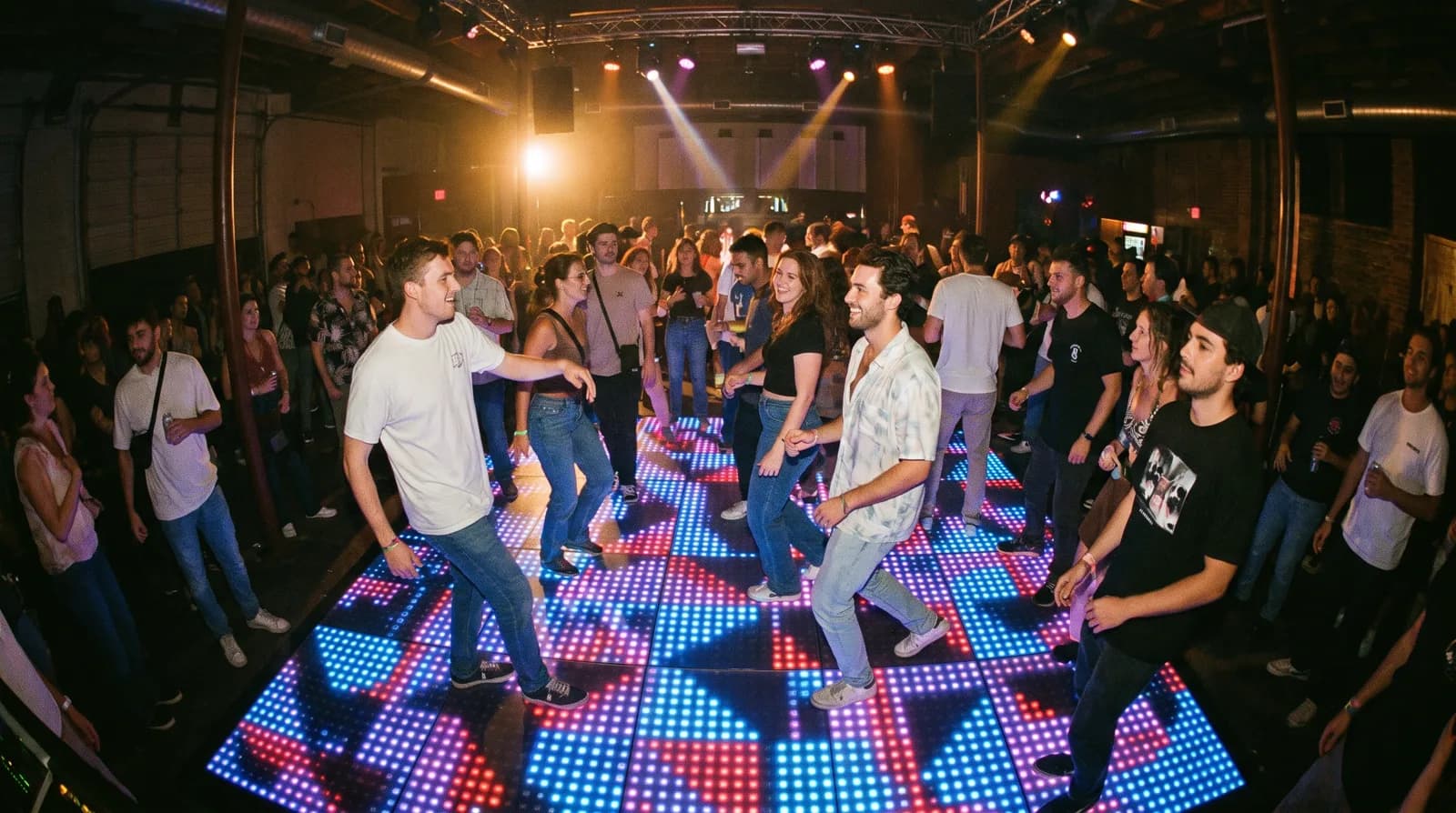An LED dance floor glowing with geometric pixel patterns