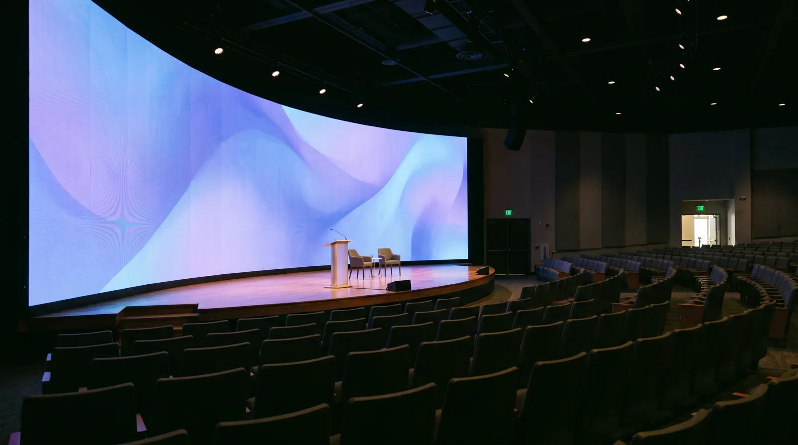 A fine-pitch LED video wall behind a corporate keynote stage